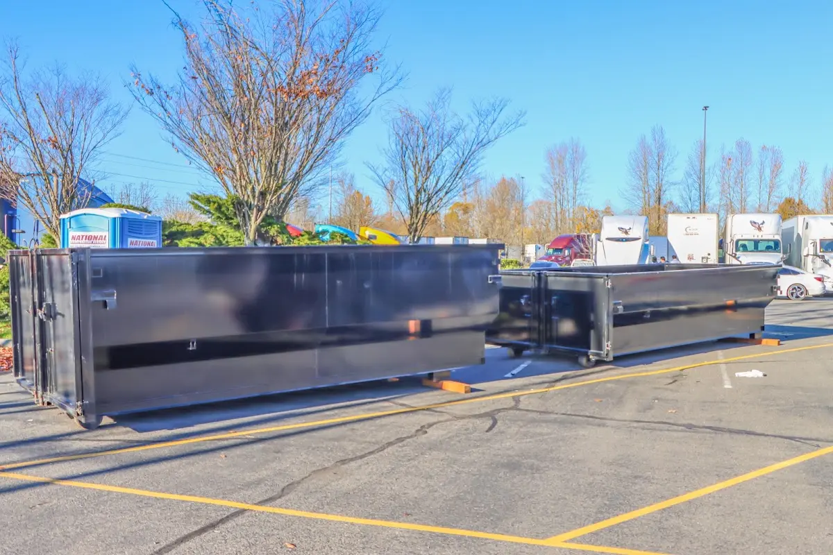 Professional dumpster rental service with roll-off container on residential driveway in South Burlington
